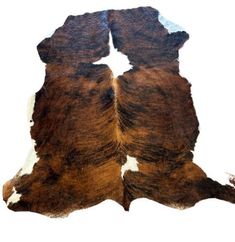 a brown and white cowhide rug on a white background