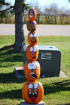 pumpkins stacked on top of each other in the shape of cartoon faces and mouths