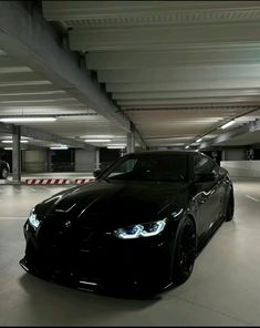 a black car parked in a parking garage