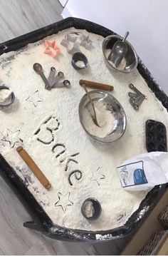 there is a cake that has been decorated with baking utensils and other items