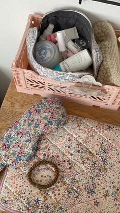 an open purse sitting on top of a table next to a pile of toiletries