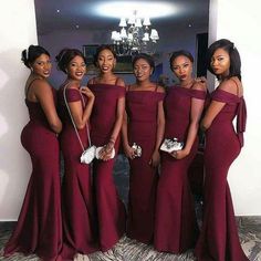 the bridesmaids are posing for a photo in their red gowns and one is holding