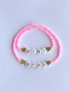 two pink and white bracelets with gold heart charms