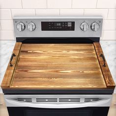 an oven with a cutting board on the front