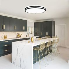 a kitchen with marble counter tops and bar stools