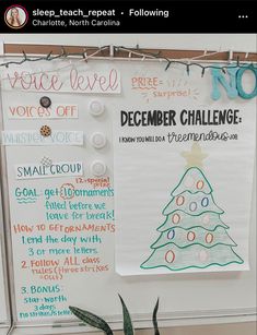 a bulletin board with writing on it and a christmas tree drawn on the wall behind it