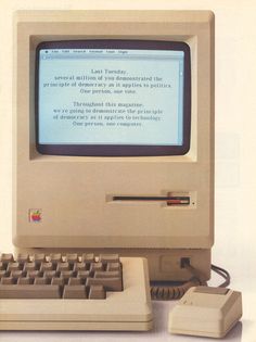 an old apple computer sitting on top of a white table next to a keyboard and mouse