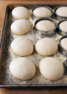 the doughnuts are ready to be baked in the tins on the baking sheet