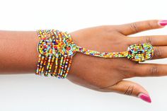 African beaded bracelets, Zulu Bracelets, Maasai Wrist bracelets, Beaded Cuff bracelets, Women jewelry, Christmas gift for her, Moms gift The bracelet is made by the Maasai women in Kenya.  It is beautiful and can compliment any outfit. Bracelet Circumference: 8 inches wide Fits a standard wrist size of 7.5 inches. If you have a larger wrist, please let me know. *Please choose your color* Shipping fee is for the first item only. Other items ship for FREE! Shipping via DHL Express that takes 3-5 Hand-strung Multicolor Beads For Gifts, Multicolor Tiny Beads Bangle, Festive Tiny Beads Bracelets, Hand-strung Beads As Gift, Adjustable Bangle Beaded Bracelets For Festivals, Colorful Beads Bracelets For Festivals, Beaded Bracelets For Party And Festivals, Adjustable Bangle With Round Beads For Festivals, Festival Tiny Beads Bangle Bracelet