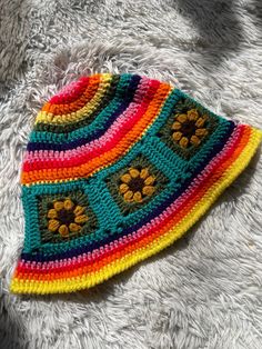 Meet this adorable rainbow sunflower sun hat made with all acrylic scrap yarns. Perfectly lightweight for summer with a floppy brim to shield your eyes from the sun's rays. Brighten up any outfit with this eclectic piece🌈💕 One size fits most (average-22.5 inch head circumference) MEASUREMENTS  *Circumference: 22 inches around when lying flat/unstretched *Diameter across top (rainbow part): 9.5 inches *Sunflower square dimensions: 4 inch wide x 3.5 inches long *Brim width: 2 inches *All scrap acrylic yarn Hand wash with cool/warm water and air dry for best results. Do not bleach or iron. Feel free to message me any questions or concerns you may have🤗 Much love Multicolor Crochet Yarn Cap, Multicolor Beanie For Spring, Multicolor Crochet Summer Hat, Summer Crochet Multicolor Hats, Handmade Colorful Crochet Hat For Beach, Multicolor Crochet Cap For Spring, Multicolor Beanie Hats For Spring, Multicolor Spring Beanie Hat, Adjustable Multicolor Knitted Sun Hat