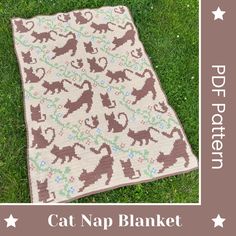 a cat nap blanket on the grass in front of a brown and white background with stars