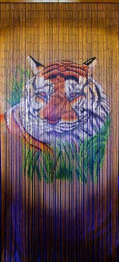 a painting of a tiger on the side of a wooden fence with grass in front of it