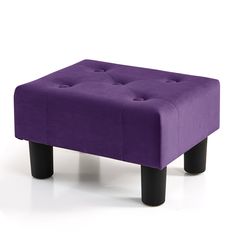 a purple ottoman sitting on top of a white floor