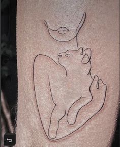 a woman's leg with a cat tattoo design on the side of her thigh