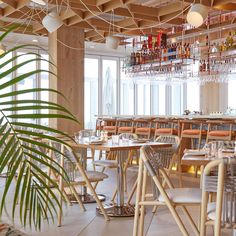 an empty restaurant with wooden tables and chairs