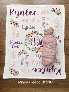 a baby wrapped in a pink blanket with flowers on it, and the name kyne written