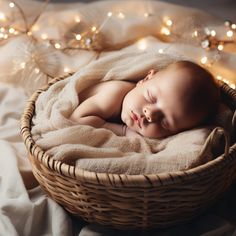 a baby is sleeping in a basket on a blanket with christmas lights around him and she has her eyes closed