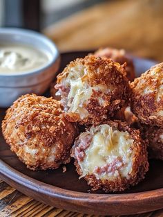 some food is sitting on a plate with dipping sauce