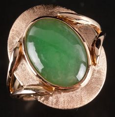 Vintage 1950's 14k Yellow Gold Oval Cabochon Jade Solitaire Cocktail Ring 6.5gMetal Information: 14k Yellow GoldTotal Weight: 6.5gBand Width: 1.9mmSize: 5.75Circa: 1950'sStone InformationMain StoneGem Type: JadeShape: Oval Cabochon (15mm x 10.2mm)Color: GreenClarity/Quality: ANumber of Stones: 1Estimated Retail Price: $2250.00OUR PRICE: $1800.00SizingMany of our pieces can be re-sized at the buyers request. Please email us if you require our skilled professional services.45577 Elegant Oval Cabochon Emerald Collectible Ring, Vintage 14k Gold Emerald Oval Cabochon Ring, Vintage 14k Gold Oval Cabochon Emerald Ring, Vintage Polished Emerald Ring With Oval Cabochon, Antique Oval Emerald Ring Stamped 14k, Vintage Emerald Oval Cabochon Ring With Polished Finish, Vintage Oval Cabochon Emerald Ring With Polished Finish, Vintage Oval Emerald Ring In 14k Gold, Vintage 14k Gold Oval Cabochon Jewelry