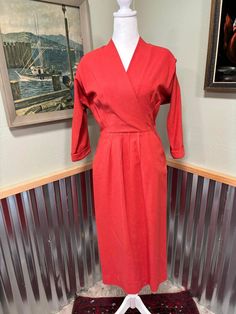 "Gorgeous 1950's Marion McCoy Originals hot pink wool dress. Pleating in the front at the skirt and has 2 open pockets. Dolman sleeves . Metal zipper up the side, has belt loops but no belt. 3/4 length cuffed sleeves. Crossover bodice and shoulder pads. Dress is in excellent condition for its age with a few issues. There is a small rip under the arm pit right above the zipper in the seam and there are several flea bites as shown in photos. Measurments are Bust 38\" Waist 26\" Hips 38\" Length 47 1930's Dresses, Wool Dress, Metal Zipper, Cuff Sleeves, Dolman Sleeve, Dress Clothes For Women, Shoulder Pads, Crossover, Vintage Dresses