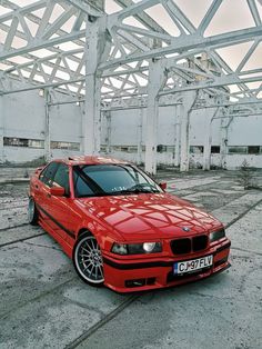 a red car parked in an empty building