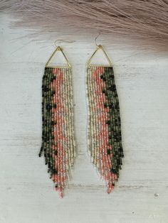 Hand beaded glass bead earrings. Hypoallergenic Hooks. Quarter placed for size reference. 5 3/4 of an inch from top of triangle to the longest point. Beaded Tipi Earrings, Bohemian Triangle Jewelry With Dangling Beads, Beaded Teepee Earrings, Trout Beaded Earrings, Adjustable Triangular Beaded Jewelry, Desert Beaded Earrings, Adjustable Triangle Beaded Jewelry, Trout Earrings, Adjustable Triangle Beaded Earrings