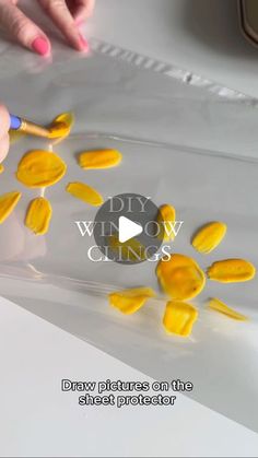 someone is painting yellow flowers on a white sheet