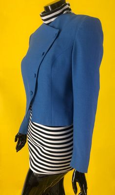 80s crop diagonal button down blazer. The striped turtle neck is not included. Perfect blazer with a trendy cut. Solid blue hue with a mildly textured fabric resembling linen. Fits like a size Medium. Blue Cropped Jacket With Button Closure, Fitted Cropped Blazer With Button Closure, Fitted Vintage Cropped Jacket, Retro Fitted Cropped Outerwear, Fitted Retro Cropped Outerwear, Retro Fitted Blue Blazer, Fitted Retro Blue Blazer, Fitted Blue Cropped Jacket, Fitted Single Breasted Cropped Jacket For Tailoring