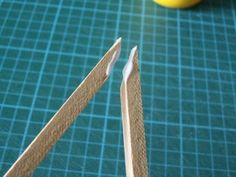 two pieces of wood sitting on top of a cutting board