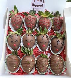 chocolate covered strawberries in a box with faces drawn on the top and sides, all decorated like strawberrys