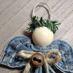 an egg sitting on top of a blue jean cloth with a wooden button in the middle