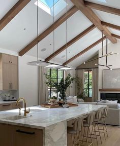 an open kitchen and living room with vaulted ceilings