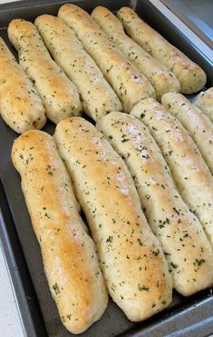 bread sticks are lined up in a baking pan