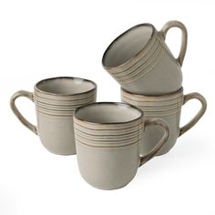 four coffee mugs stacked on top of each other