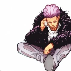 a man with pink hair sitting on the ground talking on a cell phone while wearing a fur coat