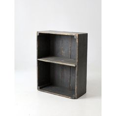 an old wooden bookcase with two shelves