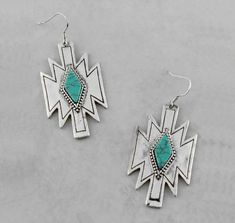 Enhance your style with our Turquoise Southwestern Aztec Earrings. These silver earrings have a striking design, with a turquoise center stone for a touch of western Aztec flair. Perfect for those looking to add some personality to their wardrobe. Introducing our Turquoise Southwestern Aztec Earrings! These statement earrings are the perfect way to add a touch of western charm to any outfit. Featuring a captivating turquoise-inspired center stone, these silver earrings are sure to make a stateme Rodeo Jewelry, Aztec Earrings, Simple Silver Jewelry, Country Jewelry, Cowgirl Jewelry, Silver Jewellery Indian, Turquoise Jewelry Native American, Turquoise Drop Earrings, Fine Silver Jewelry