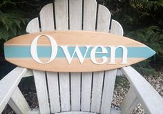 a wooden lawn chair with the word oven painted on it