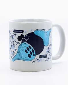 a white coffee mug with an image of a blue whale on it's side