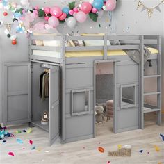 there is a loft bed in the room with balloons and confetti on the wall