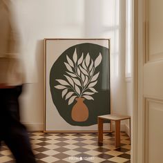 a painting on the wall next to a small stool in a room with a checkered floor