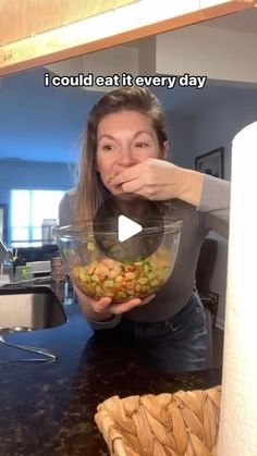 a woman holding a bowl full of food in front of her face with the caption i could eat it every day