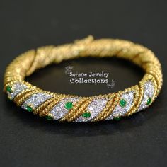 Pretty sparkly diamond weaved 18k yellow gold bracelet with mesmerizing emerald accents! The bracelet opens and closes with a latched clasp. Total Weight: 50 grams Bracelet length: 6.5 inches Precious Metal: 18k yellow gold Precious stones: -Emerald Cabochons: 1.5mm to 2.8mm, 0.8 carats -White Round Diamonds: 3 carats Luxury Green Gold Bracelet For Anniversary, Green Bangle For Formal Occasions, Fine Jewelry Style, Green Diamond Bangle Bracelet For Formal Occasions, Formal Green Diamond Bangle Bracelet, Formal Emerald Bangle, Gold Emerald Bracelets For Formal Occasions, Formal Gold Bracelets With Emerald, Elegant Gold Bangle With Emerald, Star Sapphire Ring