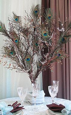 an image of a table setting with peacock feathers