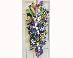 a door with a mardi gras mask hanging on it