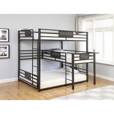 a bunk bed with two sets of mattresses on top of it in a room