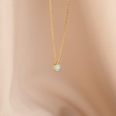 Our Opal Heart Necklace is dainty and delicate, but still has an element of fun. The light green opal gemstone is heart shaped, making it a great gift for that special someone in your life. Show them you love them with a charm necklace they can wear everyday. Material: High Quality Solid 925 Sterling Silver Finish: Sterling Silver ∙ 18K Gold Featuring a ~5x5mm Opal Heart Charm on an adjustable necklace from 16 to 18 inches Part of our Mood: Lush Green Collection Model showcases a gentle, etherea Dainty Charm Necklaces With Heart Beads For Gift, Dainty Heart Beads Charm Necklace For Gift, Dainty Charm Necklace With Heart Beads For Gift, Heart Shaped May Birthstone Necklace With Heart Charm, Dainty Heart Pendant Necklace For May Birthstone, Delicate Opal Chain Jewelry Gift, Delicate Opal Chain Jewelry As Gift, Delicate Opal Chain Jewelry For Gifts, Delicate Opal Jewelry Gift