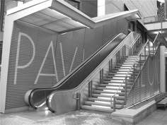 an escalator and stairs with graffiti on the wall