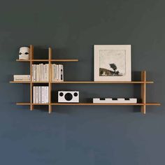 a bookshelf with two shelves and pictures on the wall