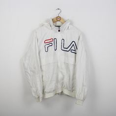 Beautifully preserved vintage rain jacket in size S-M from Fila. With working full zipper. With a nice logo (see picture). With hood and 2 side pockets. Hood housed in the collar. Elastics on the sleeve ends are still OK. Poly fabrics (exact material details on request). You can find more rain jackets, windbreakers and other vintage clothes in our Etsy shop. If you have any questions, just write to us! Your soul & style from Berlin P.S.: Our clothes are vintage, so not new. We list defects that Fila Windbreaker, Vintage Clothes, Your Soul, Vintage 90s, Rain Jacket, Vintage Outfits, Jackets & Coats, Adult Outfits, Etsy Shop